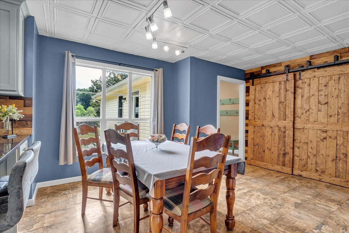 413 Walden Ridge Road Manchester, TN 37355 - Photo 30 of 71 a view of a dining room with furniture large windows and wooden floor