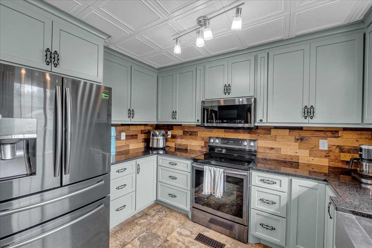 413 Walden Ridge Road Manchester, TN 37355 - Photo 37 of 71 a kitchen with granite countertop white cabinets and stainless steel appliances