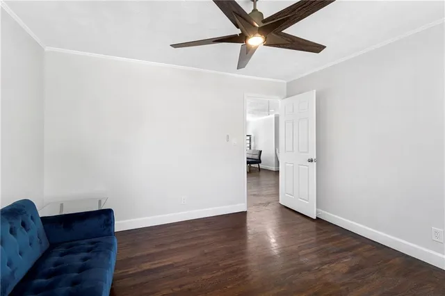 a big room with wooden floor and windows