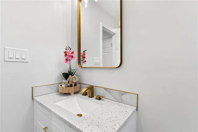 a bathroom with a sink vanity and a mirror