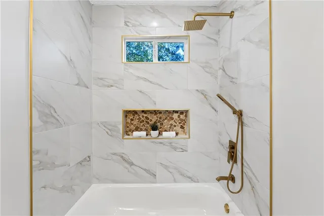 a bathroom with a shower and a bath tub
