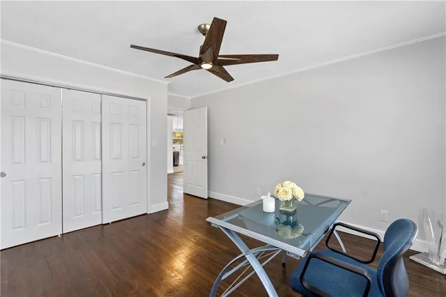 a workspace with furniture and chandelier fan