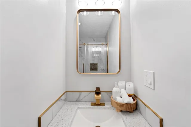 a bathroom with a sink and mirror
