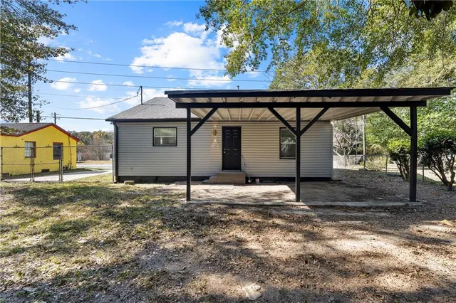 a view of a house with a yard and garage