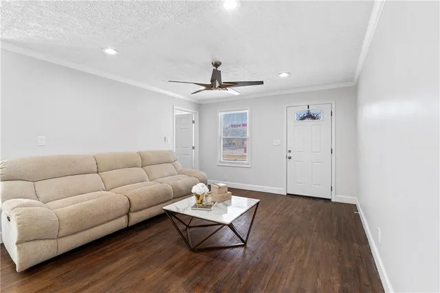 a living room with furniture and wooden floor