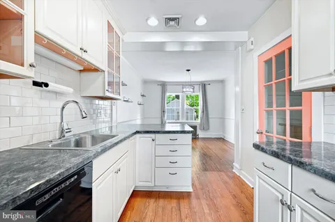 a kitchen with stainless steel appliances granite countertop a sink stove and cabinets