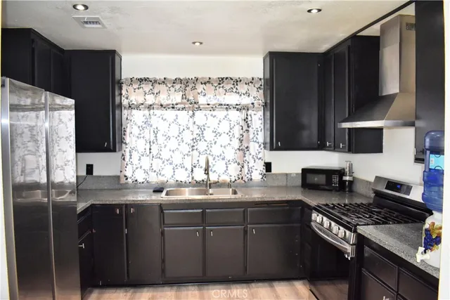 a kitchen with a sink stove and refrigerator