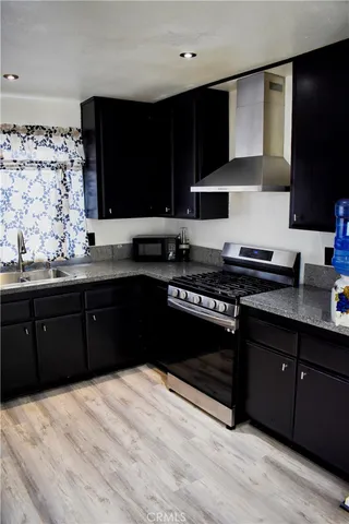 a kitchen with a sink stove and microwave