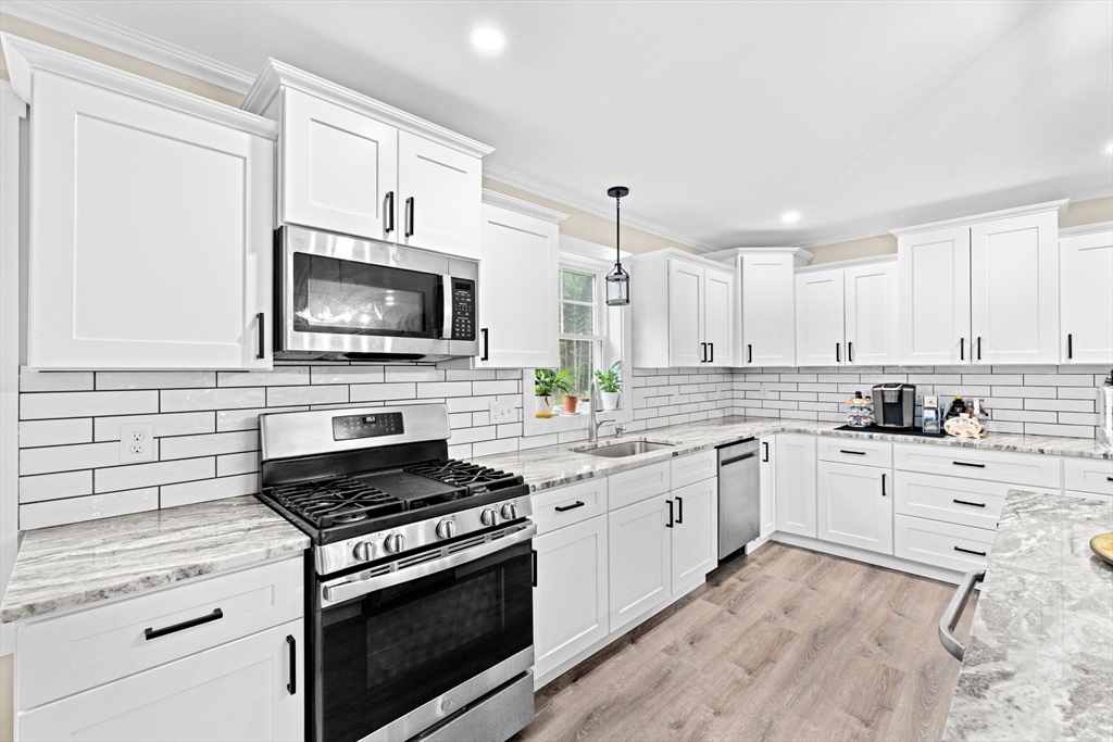 8 Big River Road Coventry, RI 02816 - Photo 12 of 42 a kitchen with cabinets stainless steel appliances and a sink