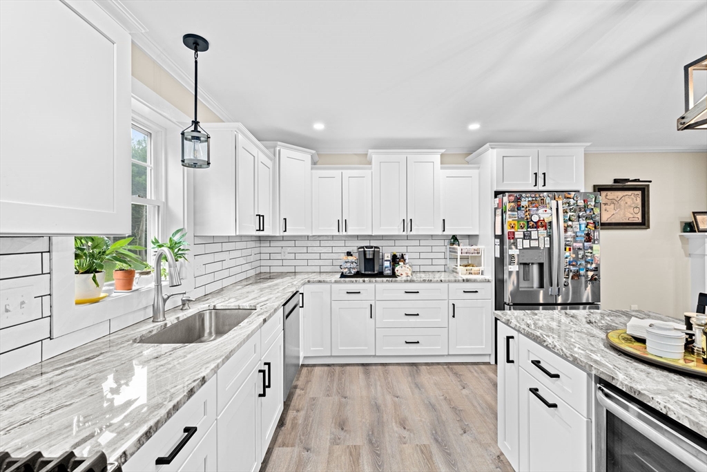 8 Big River Road Coventry, RI 02816 - Photo 13 of 42 a kitchen with stainless steel appliances kitchen island granite countertop a sink stove and cabinets