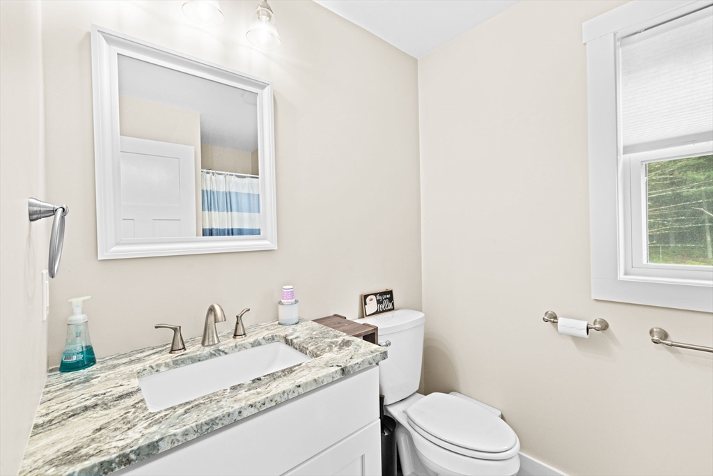 8 Big River Road Coventry, RI 02816 - Photo 18 of 42 a bathroom with a granite countertop sink mirror vanity and toilet