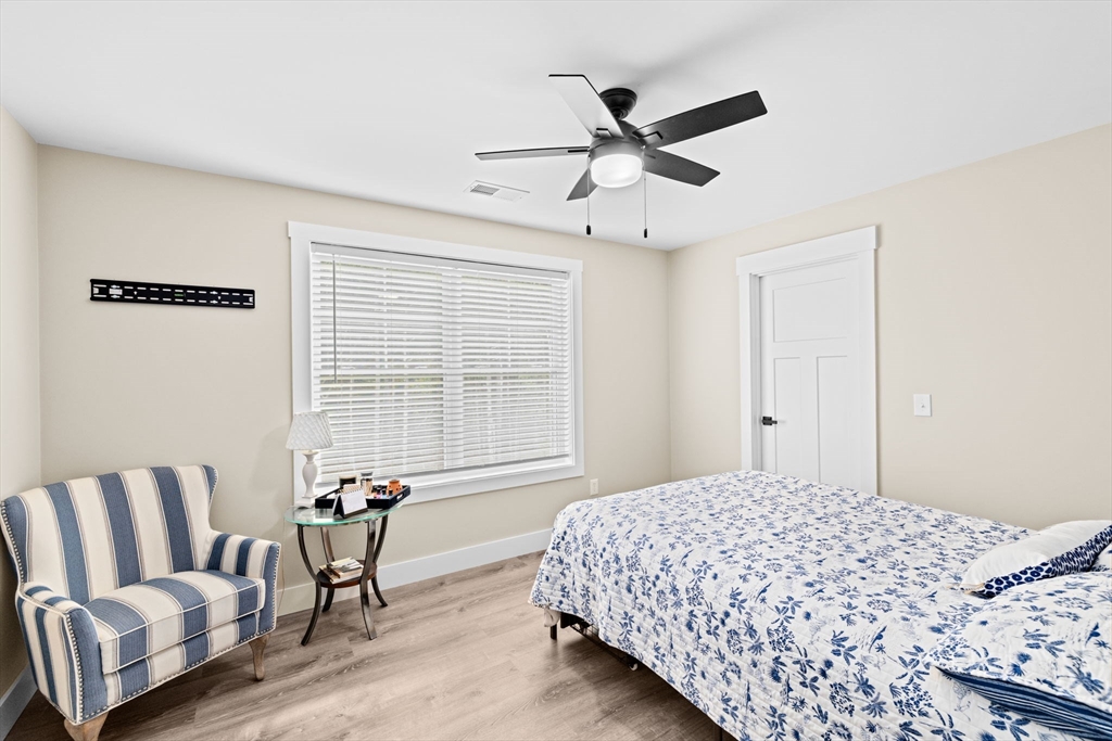 8 Big River Road Coventry, RI 02816 - Photo 24 of 42 a bedroom with a bed and wooden floor