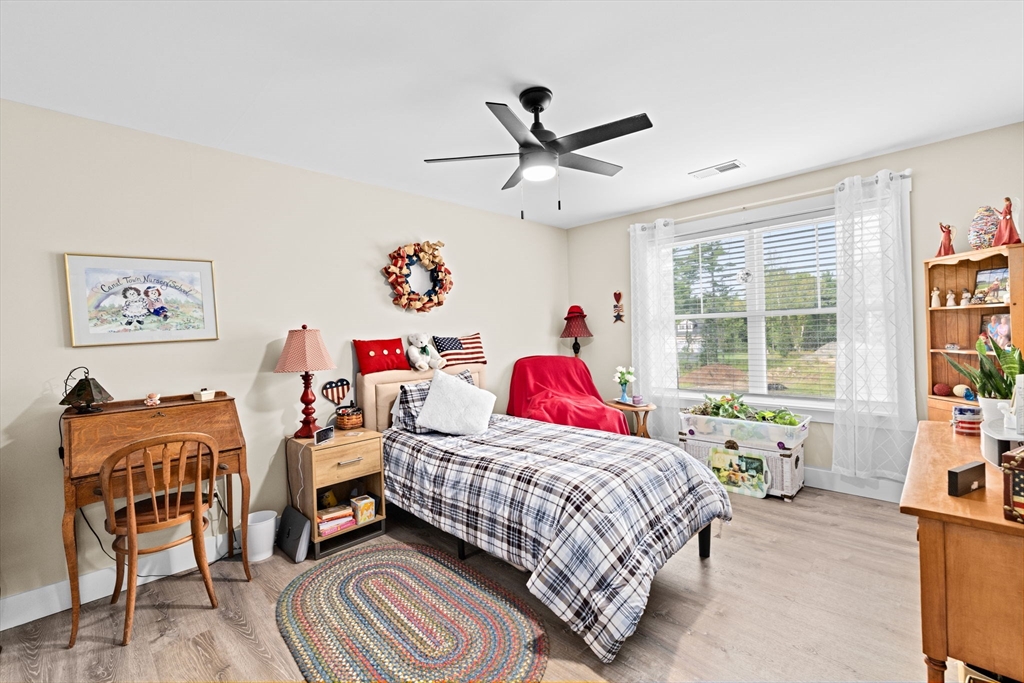 8 Big River Road Coventry, RI 02816 - Photo 26 of 42 a bedroom with a bed and a chandelier