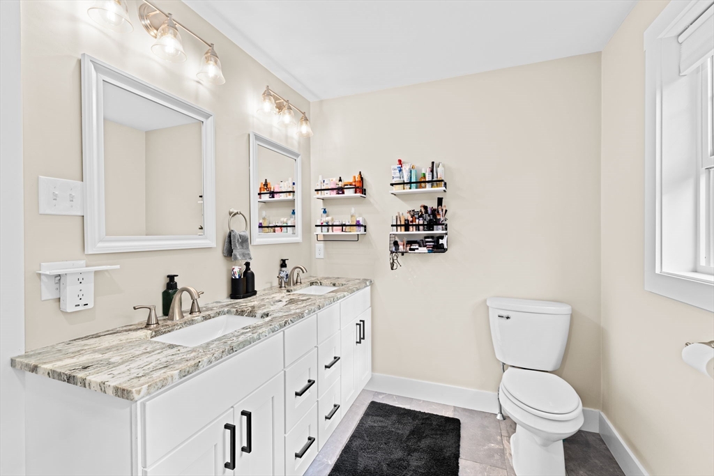 8 Big River Road Coventry, RI 02816 - Photo 31 of 42 a bathroom with a granite countertop toilet sink and mirror