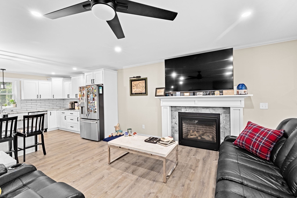 8 Big River Road Coventry, RI 02816 - Photo 4 of 42 a living room with furniture a flat screen tv and a fireplace