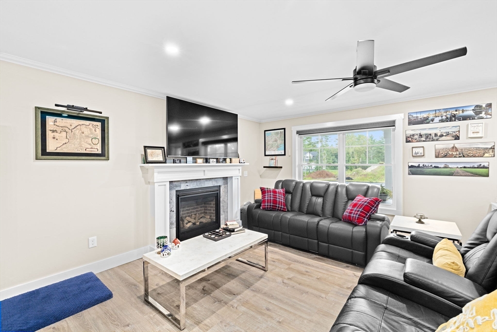 8 Big River Road Coventry, RI 02816 - Photo 7 of 42 a living room with furniture a flat screen tv and a fireplace