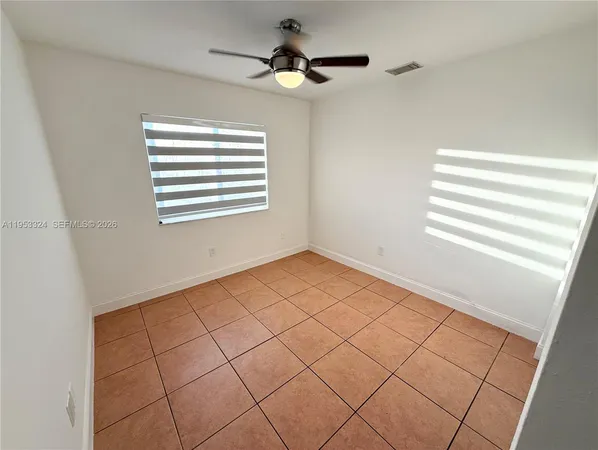 a view of an empty room and a window
