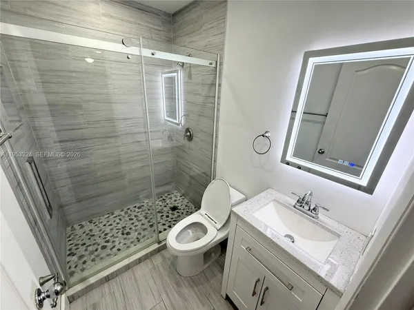 a bathroom with a sink toilet and shower