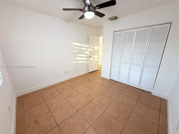 a view of a livingroom with wooden floor and a ceiling fan