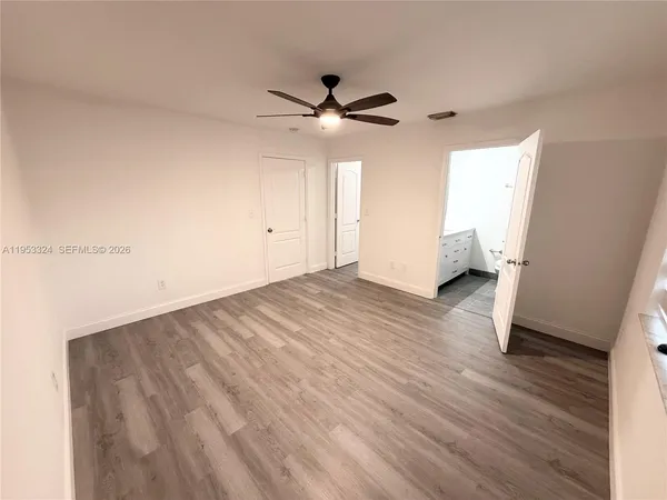 a bathroom with a toilet sink double vanity and mirror