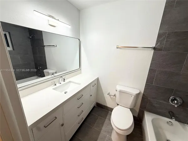 a bathroom with a toilet and a bathtub