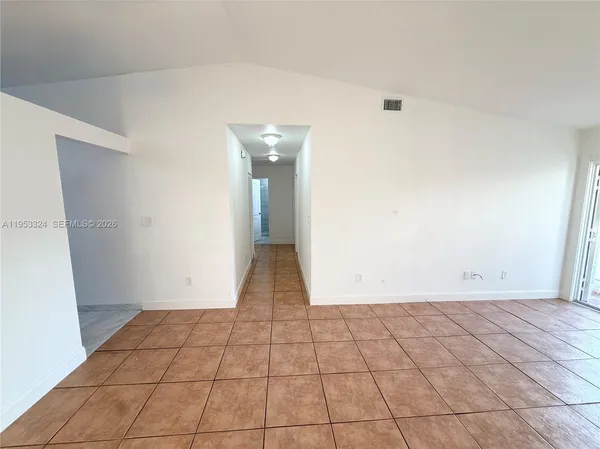 a view of an empty room and a window