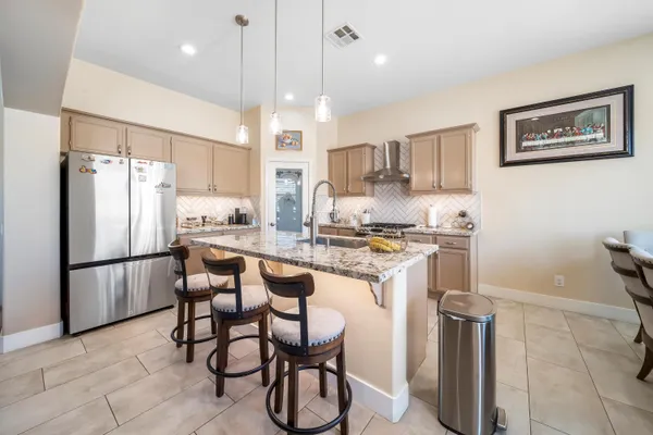 a kitchen with refrigerator cabinets and furniture