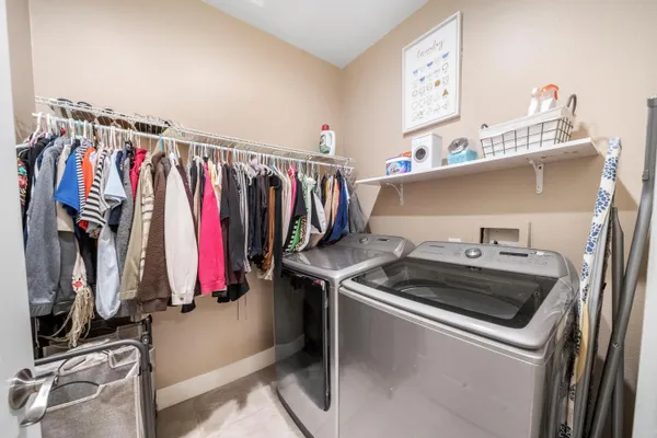 a view of walk in closet with clothes
