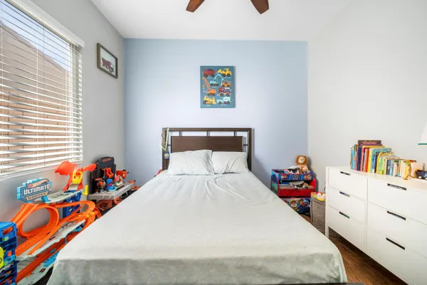 a bedroom with a bed and a dresser in it