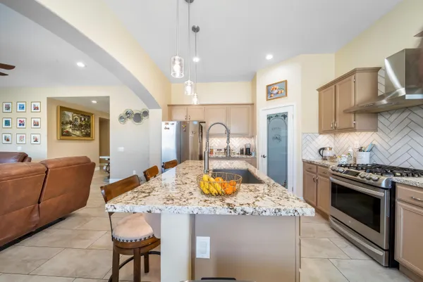 a kitchen with a stove and a refrigerator