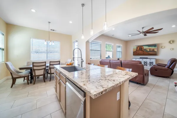 a large kitchen with a counter space and dining table