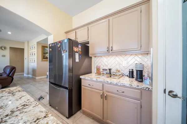 a kitchen with a refrigerator sink and cabinets