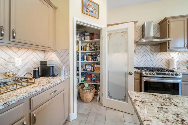 a kitchen with stainless steel appliances granite countertop a stove and a refrigerator