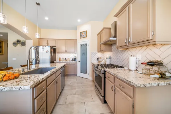 a kitchen with stainless steel appliances granite countertop a sink and cabinets