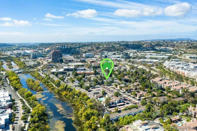 an aerial view of residential building with green space