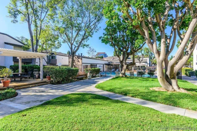 a view of a patio with table and chairs under an umbrella