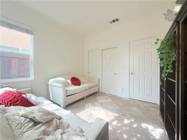 a living room with a couch and a potted plant