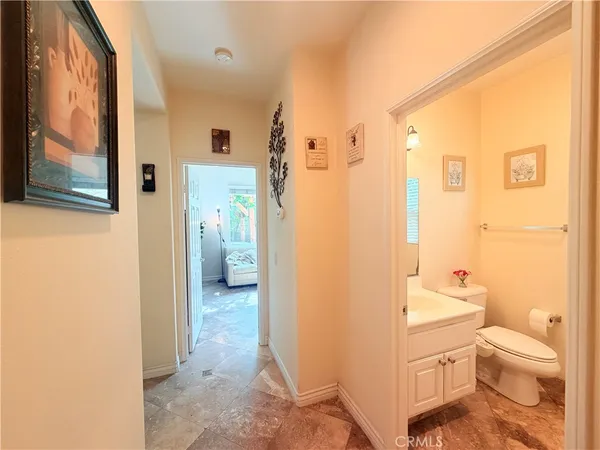 a bathroom with a granite countertop toilet sink and shower