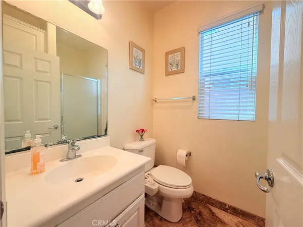 a bathroom with a sink a toilet and mirror