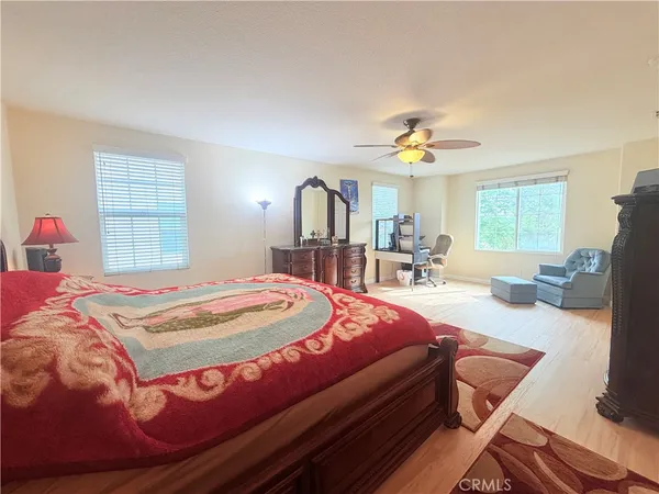 a bed room with a bed window and table