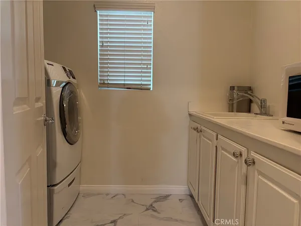 a utility room with a sink dryer and washer