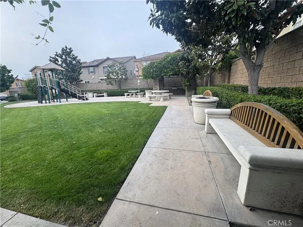 a view of a patio with couches and a table and chairs with garden view
