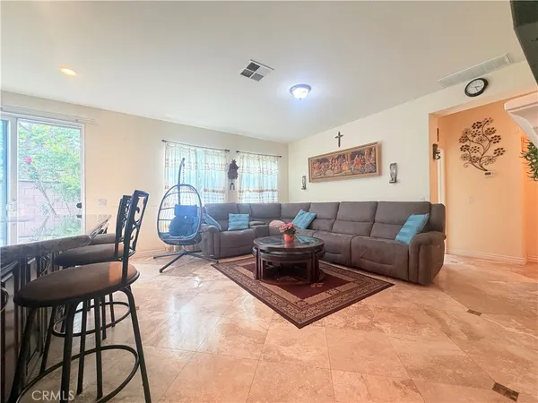 a living room with furniture a large window and a flat screen tv
