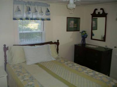 18 Edgewood Road Dennis Port, MA 02639 - Photo 8 of 21 a bedroom with a bed and a mirror