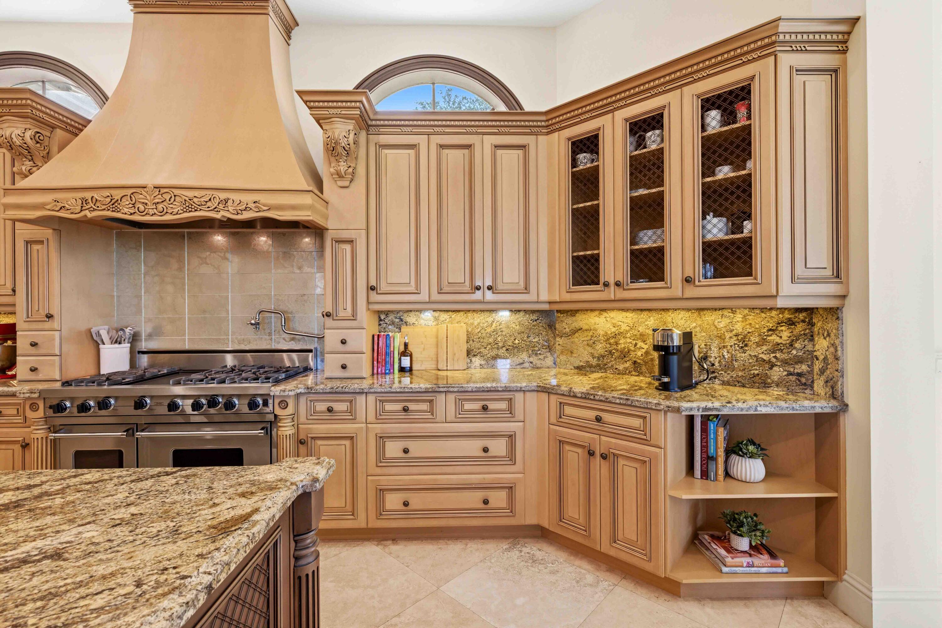 18118 Daybreak Drive Boca Raton, FL 33496 - Photo 25 of 84 a kitchen with a stove and a wooden cabinets
