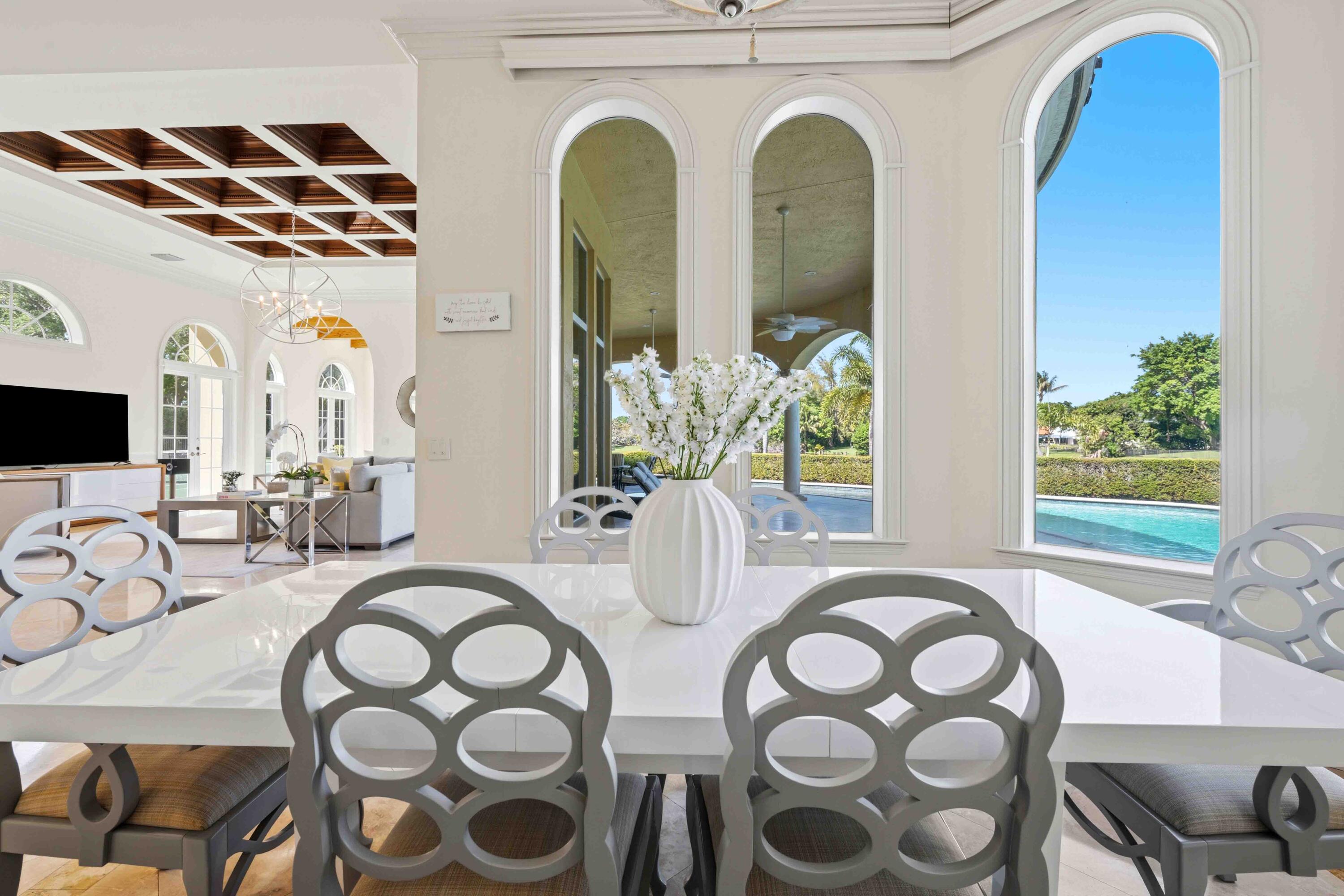 18118 Daybreak Drive Boca Raton, FL 33496 - Photo 28 of 84 a view of a dining room with furniture and chandelier
