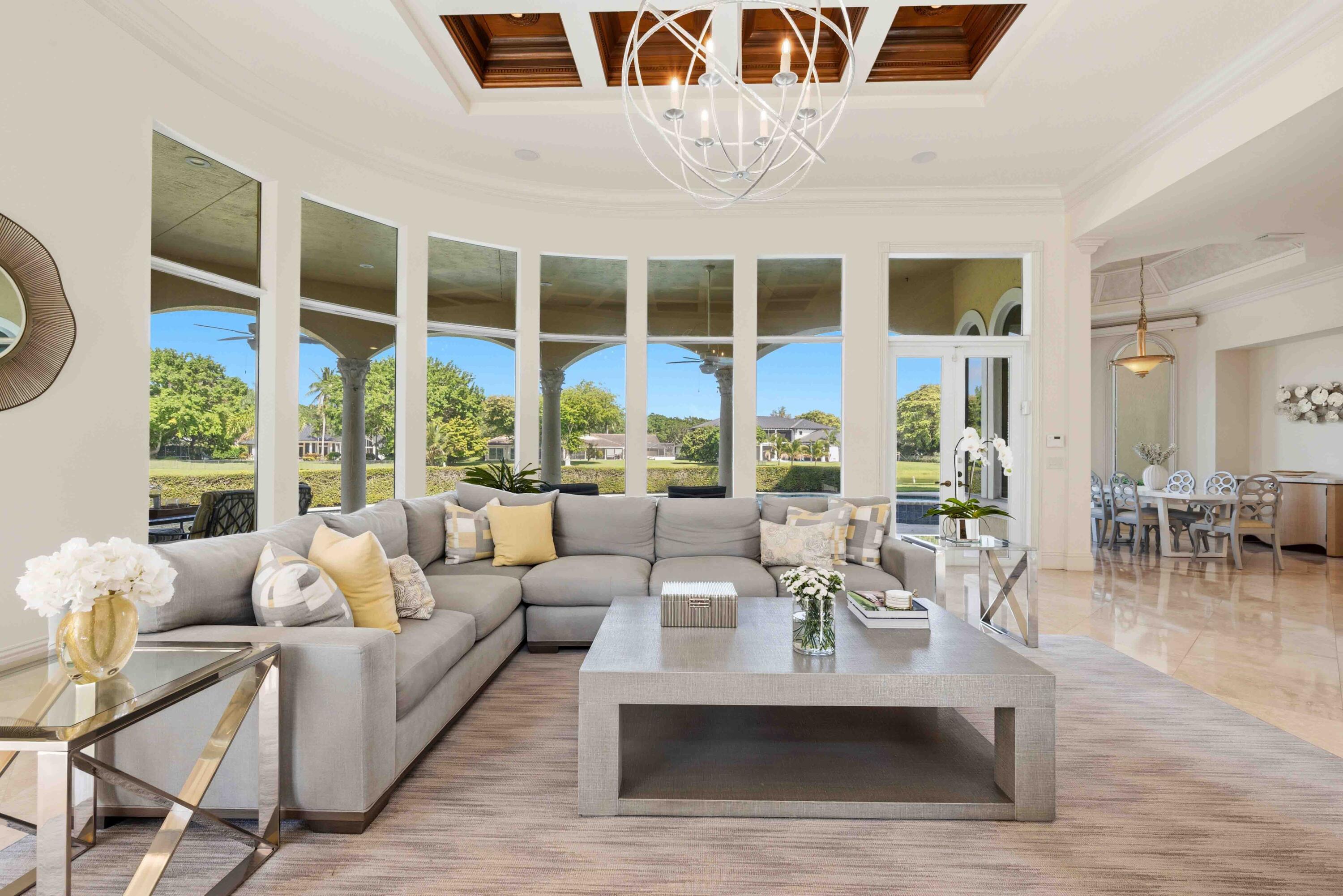 18118 Daybreak Drive Boca Raton, FL 33496 - Photo 31 of 84 a living room with furniture large windows and wooden floor