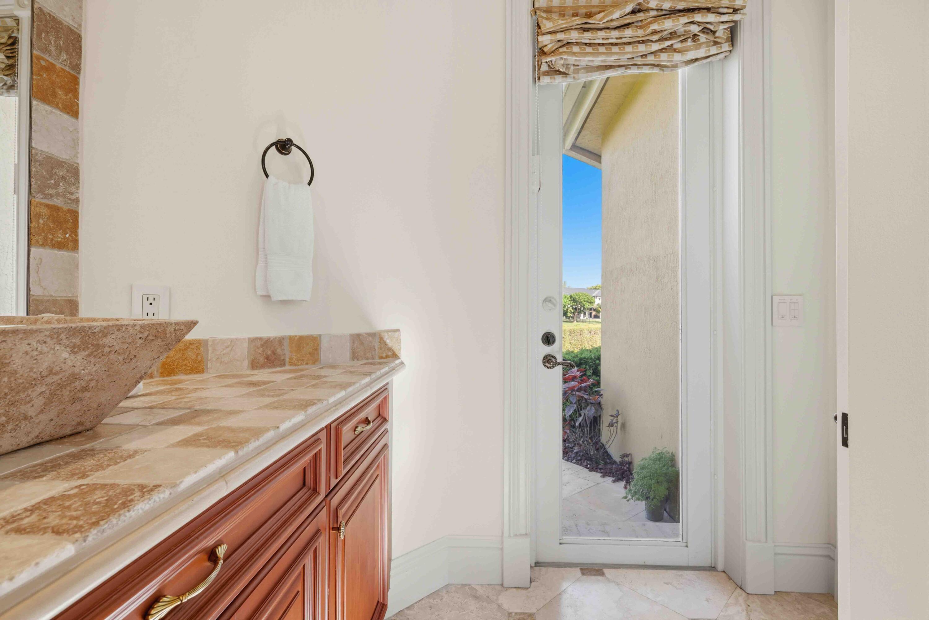 18118 Daybreak Drive Boca Raton, FL 33496 - Photo 38 of 84 a bathroom with a granite countertop sink and a mirror