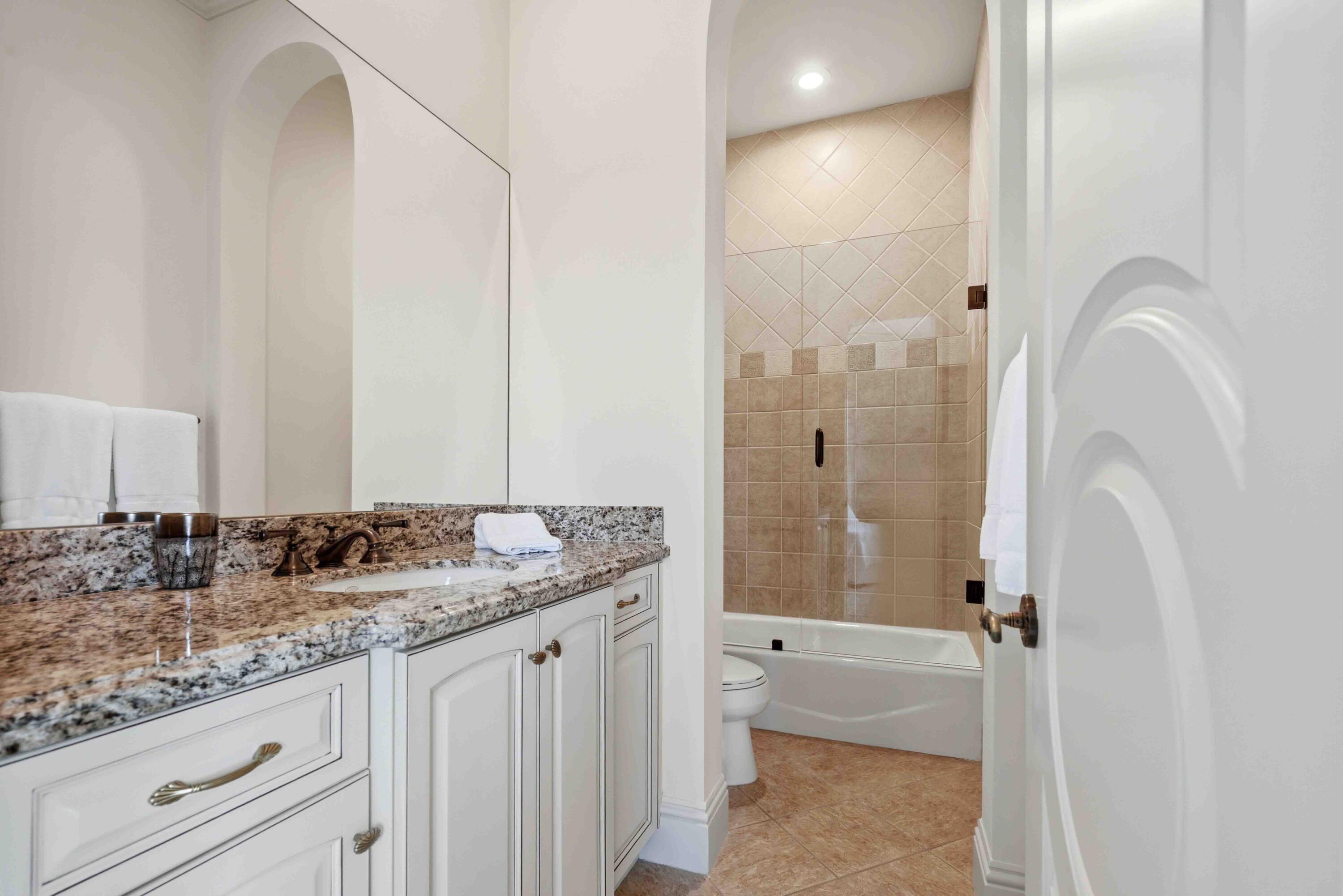 18118 Daybreak Drive Boca Raton, FL 33496 - Photo 47 of 84 a bathroom with a granite countertop sink and a mirror