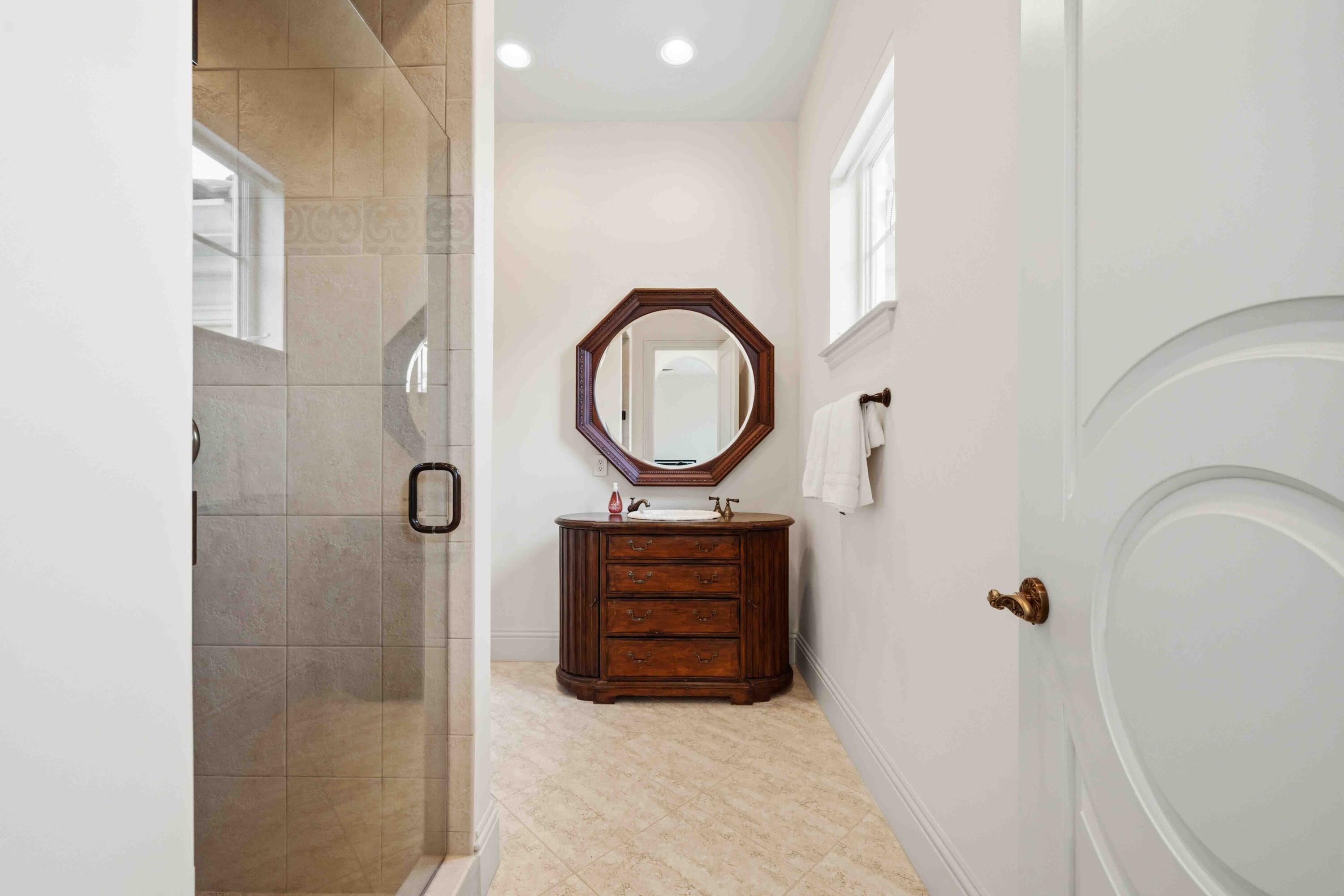 18118 Daybreak Drive Boca Raton, FL 33496 - Photo 51 of 84 a bathroom with a sink a mirror and shower